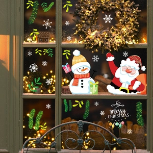 Christmas window decals with Santa, snowman and snowflakes on glass with warm lights