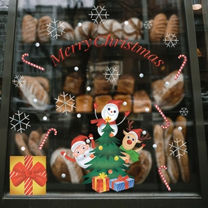 Festive Christmas window decals featuring Santa, snowman and reindeer on bakery glass