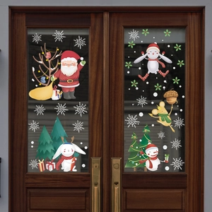 Detail of Christmas window stickers featuring Santa, snowman and deer on glass doors