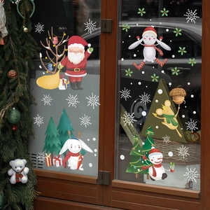 Christmas window decals with Santa Claus reindeer and snowflakes on glass door background