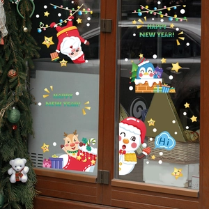Christmas window stickers showing Santa, penguins, and snowman on a festive glass door
