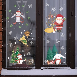 Christmas window stickers featuring Santa Claus and reindeer on a snowy glass background
