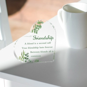 Heart-shaped clear acrylic desktop ornament with green leaf patterns and friendship quotes