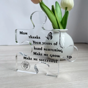 Acrylic puzzle ornament with floral print and warm message on a wooden desk