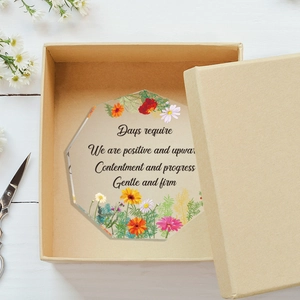 Detailed macro view of an octagonal acrylic flower ornament with motivational English text
