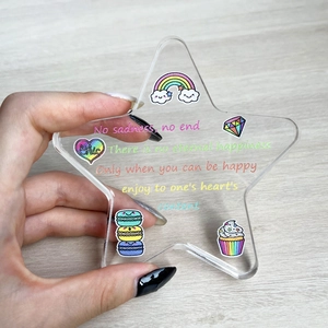 Detail of star-shaped acrylic plaque with colorful cartoon patterns and inspirational quotes