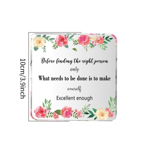 Close-up of square acrylic decor with floral watercolor pattern and motivational quote