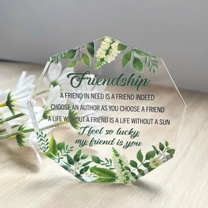 Macro detail of hexagonal clear acrylic plaque with floral motifs and friendship text