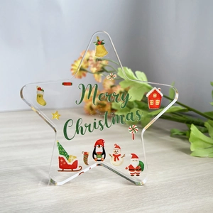 Star-shaped acrylic Christmas ornament with colorful festive patterns and Merry Christmas text