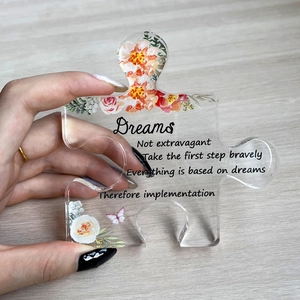 Detail of puzzle acrylic plaque with flowers, butterfly and inspiring quote on dreams