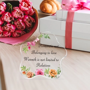 Detail of wave-shaped acrylic plaque with floral illustrations and romantic quotes