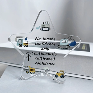 Detail of star-shaped acrylic plaque featuring motivational text and cartoon trucks