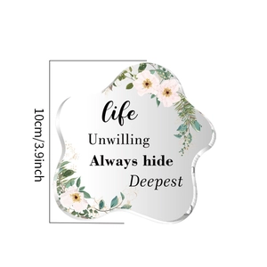 Detailed view of irregular star-shaped acrylic decor with pink floral print and quote