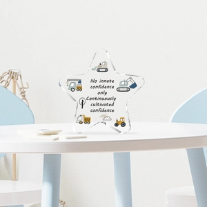 Star-shaped acrylic table decor with construction truck graphics and motivational quotes
