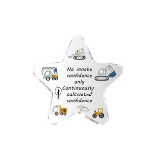 Star-shaped acrylic table decor featuring cartoon construction vehicles and motivational quote