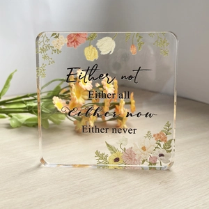 Close-up of square acrylic desk plaque with floral print and inspirational quote