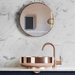 Rose gold round countertop basin set with sleek single handle faucet on marble wall