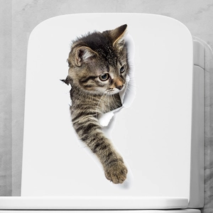 Close-up of a 3D cat wall sticker with a realistic kitten peeping from a broken wall