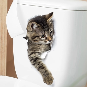 Detail of 3D tabby cat wall sticker appearing through a hole on a white toilet tank