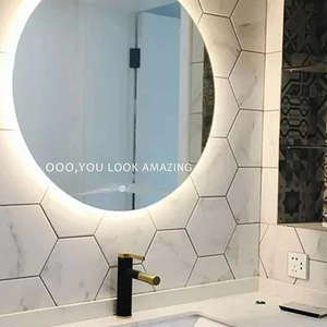 Modern round LED backlit bathroom mirror with You Look Amazing text on marble wall