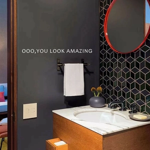 Modern wall sticker featuring 'YOU LOOK AMAZING' slogan on a minimalist bathroom wall
