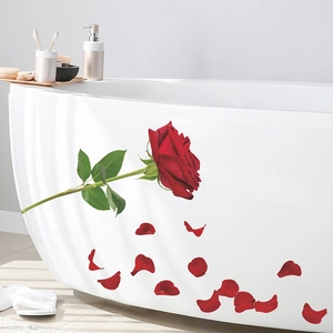Detail of red rose and falling petals wall sticker on a white minimalist bathtub