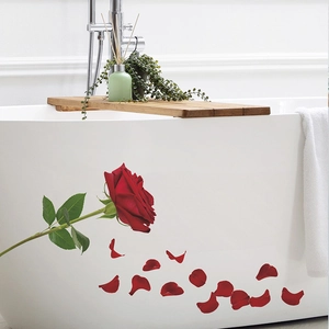 Detail of red rose wall decal with petals applied on a white bathtub in a bathroom
