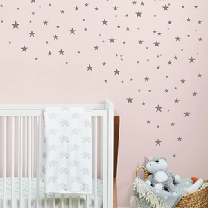 Kinderzimmer Wandgestaltung mit grauen Sternenaufklebern über einem Babybett Set