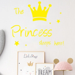Détail du sticker mural jaune Princess sleeps here avec couronne et étoiles dans la chambre