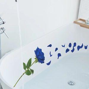 Self-adhesive dark blue rose wall stickers with scattered petals on a white bathtub