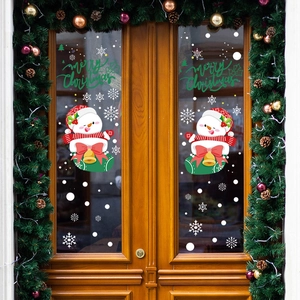 Merry Christmas snowman window stickers with snowflakes on glass door with wreath