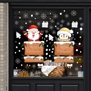 Christmas window decals with Santa Claus and penguin on glass door for holiday home decoration