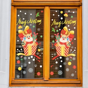 Christmas window stickers featuring reindeer and snowflakes on a wooden window pane