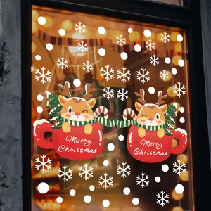 Christmas window stickers featuring cartoon reindeer in mugs with white snowflakes decor