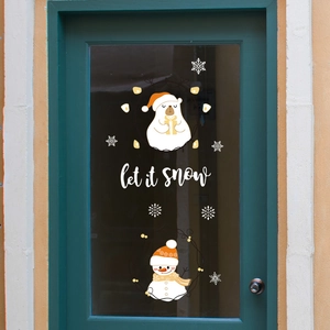 Christmas window decals with polar bear, snowman and Let it snow text on green glass door