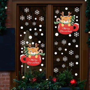 Christmas window decals with cartoon reindeer and snowflakes on a glass window pane