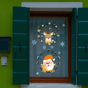 Christmas Santa and reindeer static window decals on a rustic green wooden frame glass