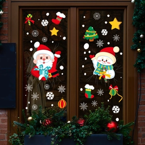 Christmas window stickers with Santa, snowman and snowflakes on wooden frame glass