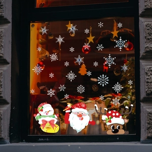 Detail of Christmas window stickers featuring Santa, snowman, and reindeer on glass
