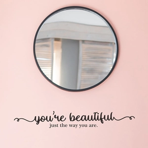 Inspirational 'you're beautiful' black vinyl wall decal under a round mirror decor