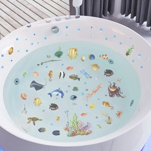 Detailed view of sea turtles and dolphins wall decals on a white bathtub in a bright bathroom