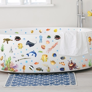Vibrant ocean animal wall decals featuring sea turtles and dolphins on a white bathtub
