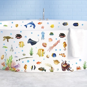 Cartoon ocean animal wall decals featuring sea turtles and dolphins on a white bathtub