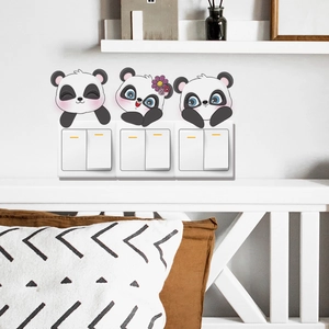 Three cute panda cartoon stickers for light switch decoration on a white wall