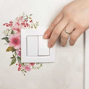 Self-adhesive floral switch wall sticker featuring pink blossoms and green leaves