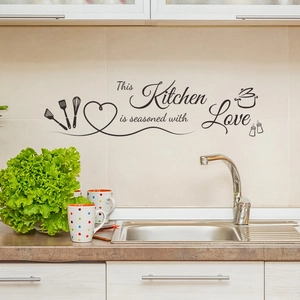 Kitchen wall decal featuring This Kitchen is seasoned with Love lettering and utensils