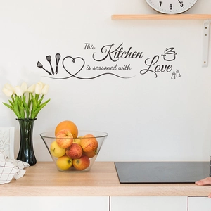 Kitchen wall decal featuring 'Seasoned with Love' text and kitchenware icons on white wall