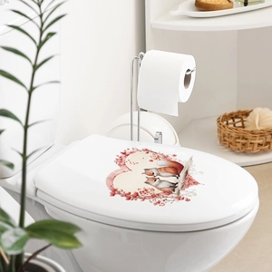 Close-up of cute cartoon fox couple wall sticker on a white bathroom toilet lid