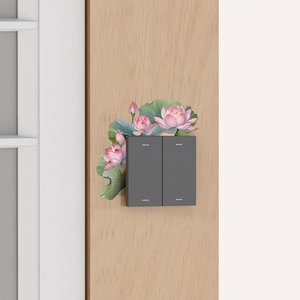 Detail of pink lotus wall sticker around a double light switch on wooden wall