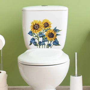 Detailed close-up of sunflower decals with blue-grey leaves on a white toilet tank